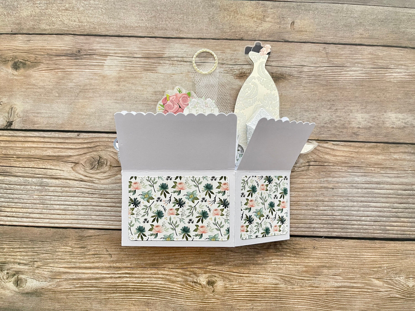 3D box style pop-up card with floral pattern on a wooden surface