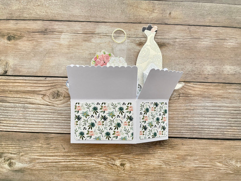 3D box style pop-up card with floral pattern on a wooden surface