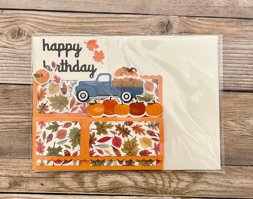 Birthday card with vintage truck and pumpkins design on a wooden surface