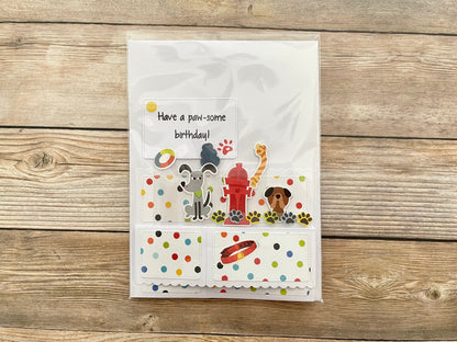 Children's birthday card with cartoon dogs and a fire hydrant on a wooden surface
