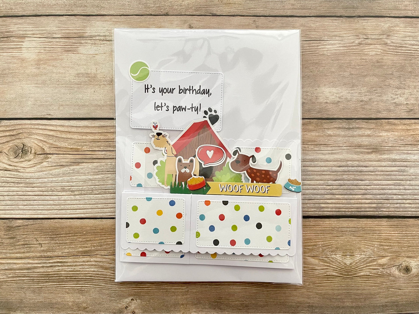 Greeting card with dog-themed illustrations on a wooden surface
