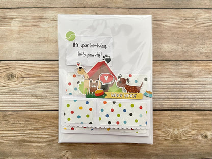 Greeting card with dog-themed illustrations on a wooden surface