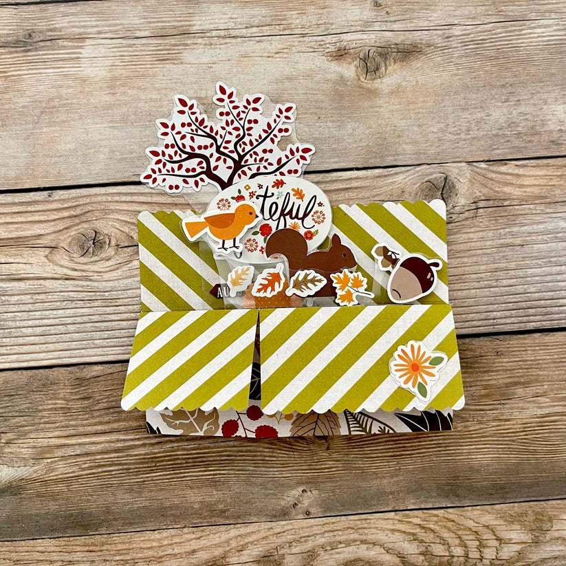 3D box pop-up card with autumn-themed stickers on a wooden surface