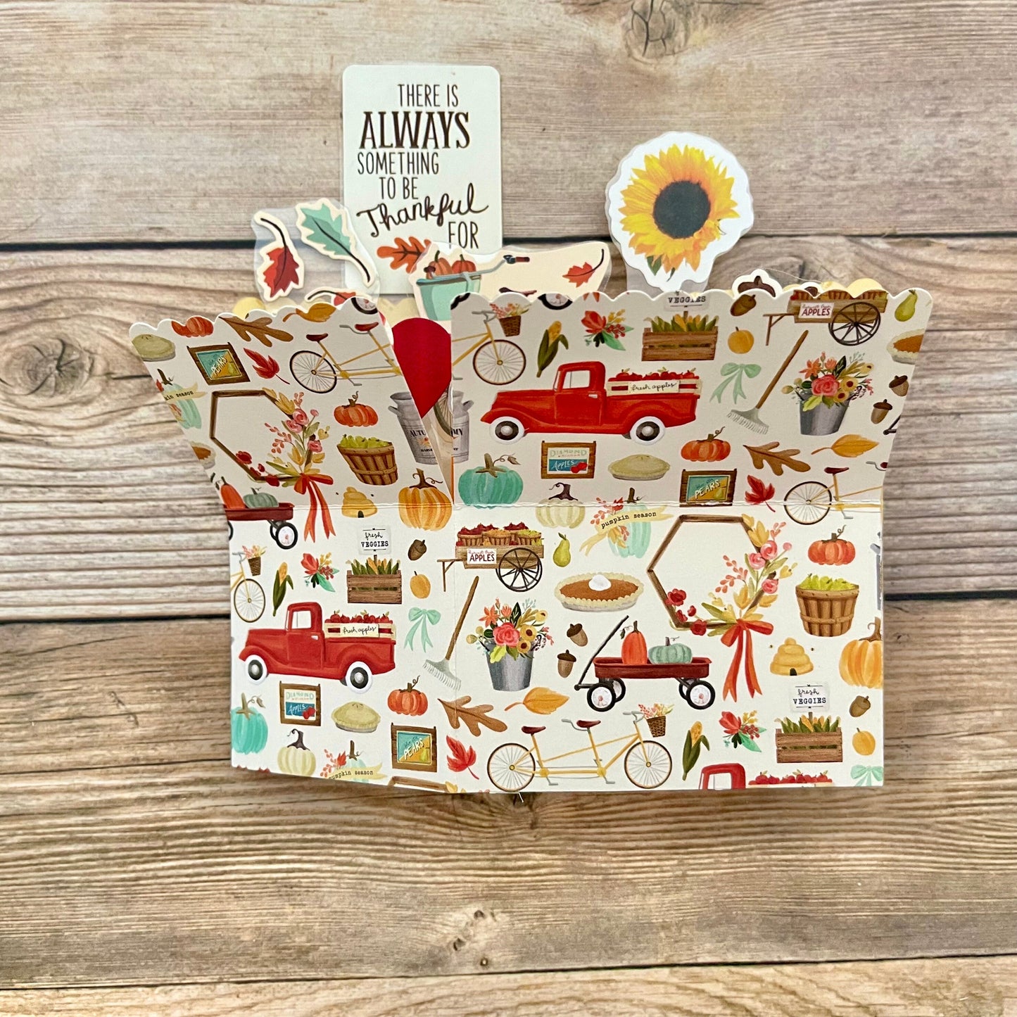 Decorative 3D box pop-up card with autumn-themed illustrations on a wooden surface
