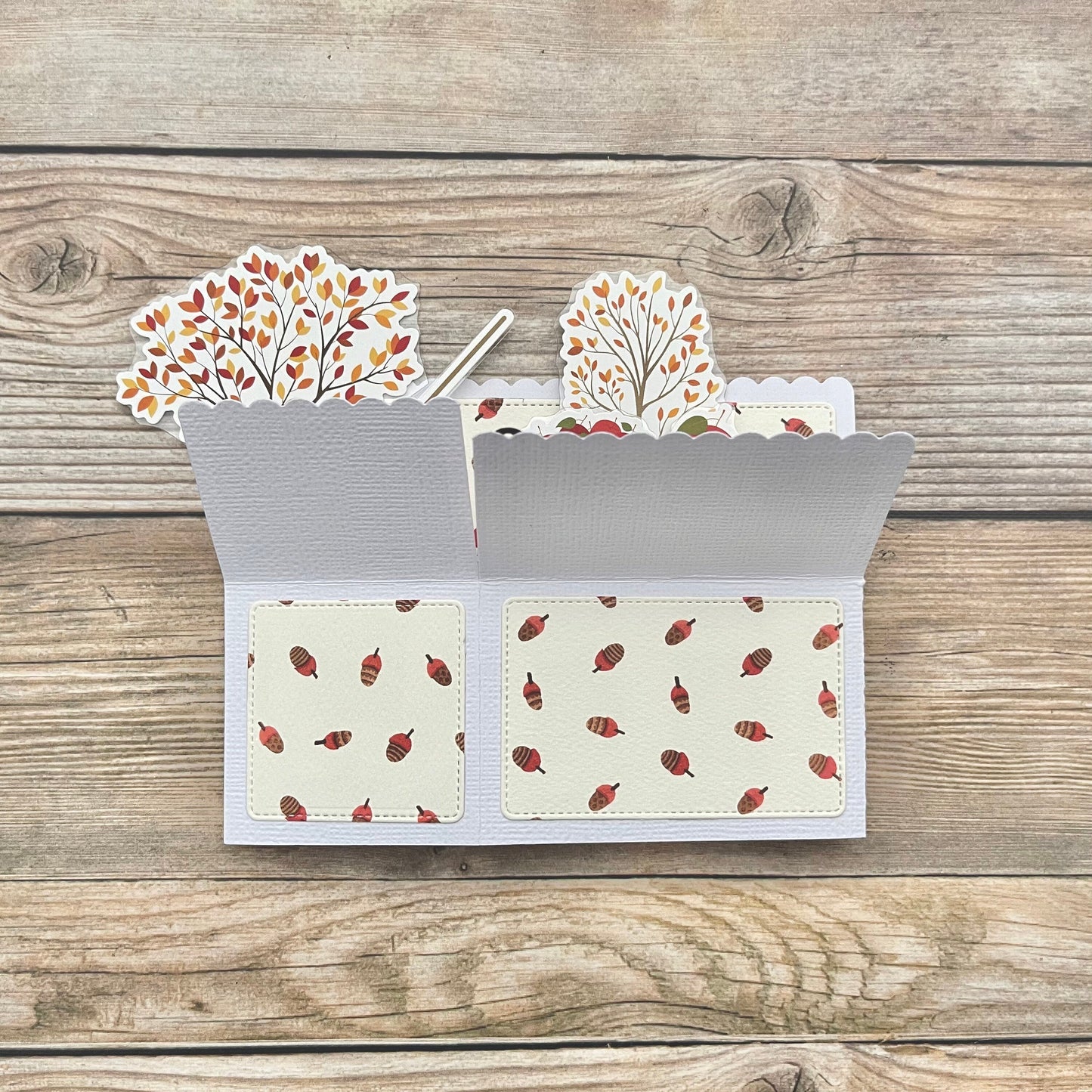 Card with autumn-themed design on a wooden surface