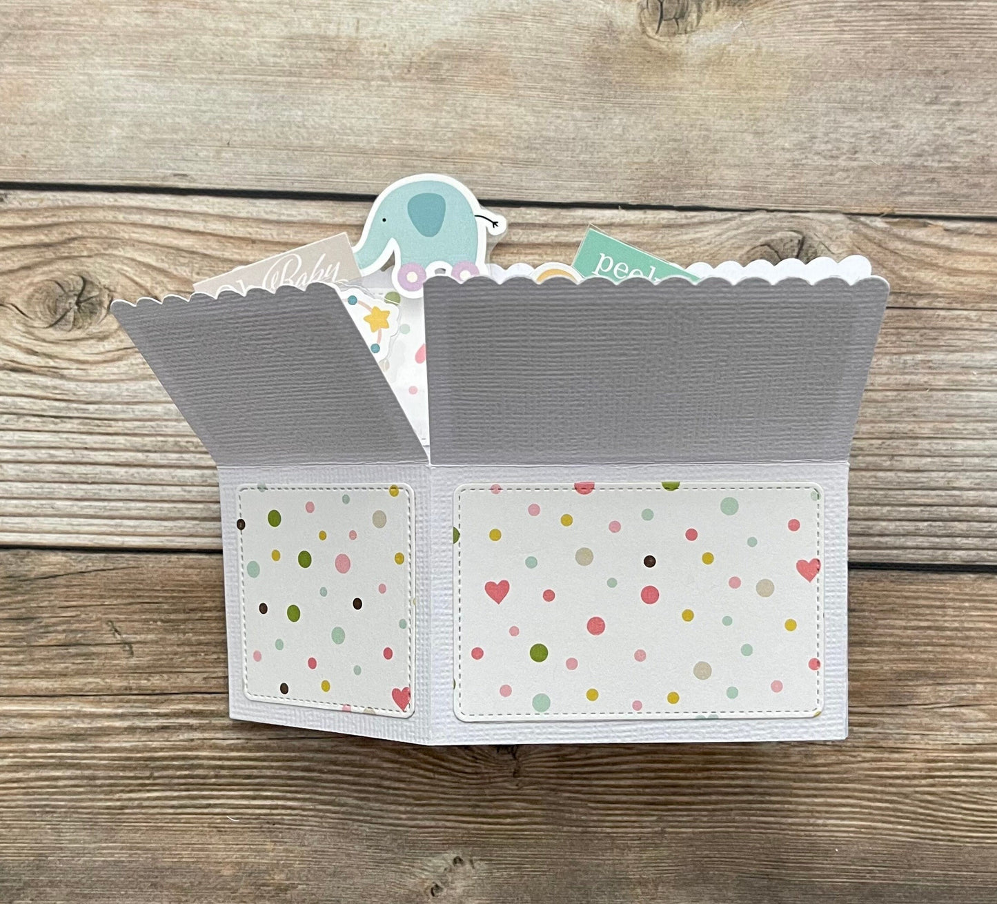 Folded pop-up card with patterned exterior on a wooden surface