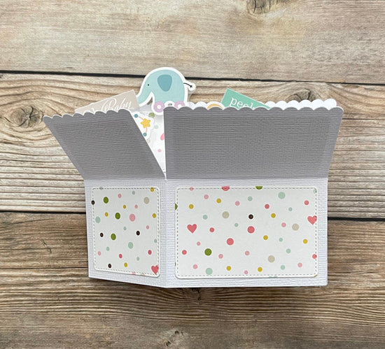 Folded pop-up card with patterned exterior on a wooden surface