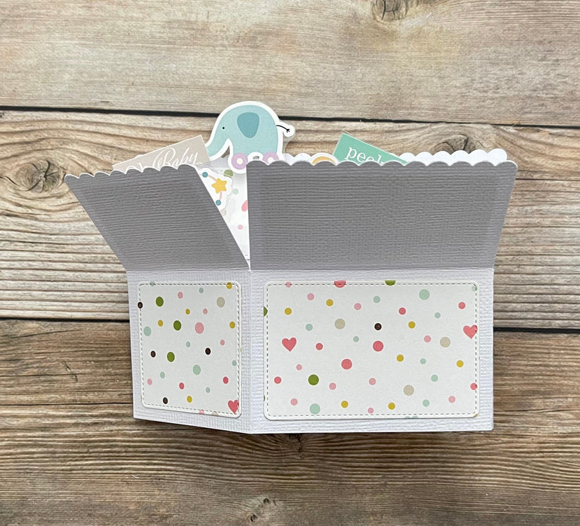 Folded pop-up card with patterned exterior on a wooden surface