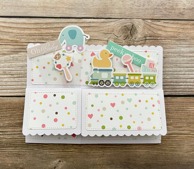 Baby pop-up card with cute toys and message of Oh, baby.