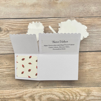 Back of pop-up card on a wooden surface