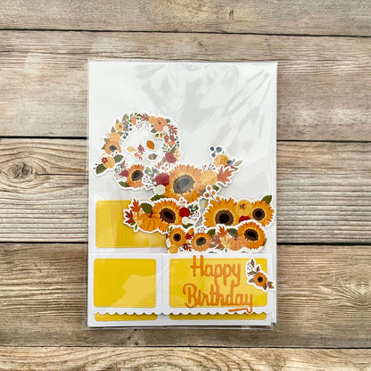 Birthday card with sunflowers and pumpkins on a wooden surface