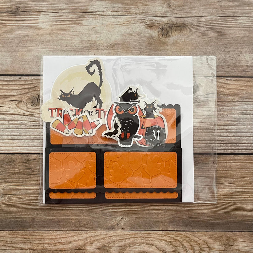 Halloween-themed stickers in a clear package on a wooden surface