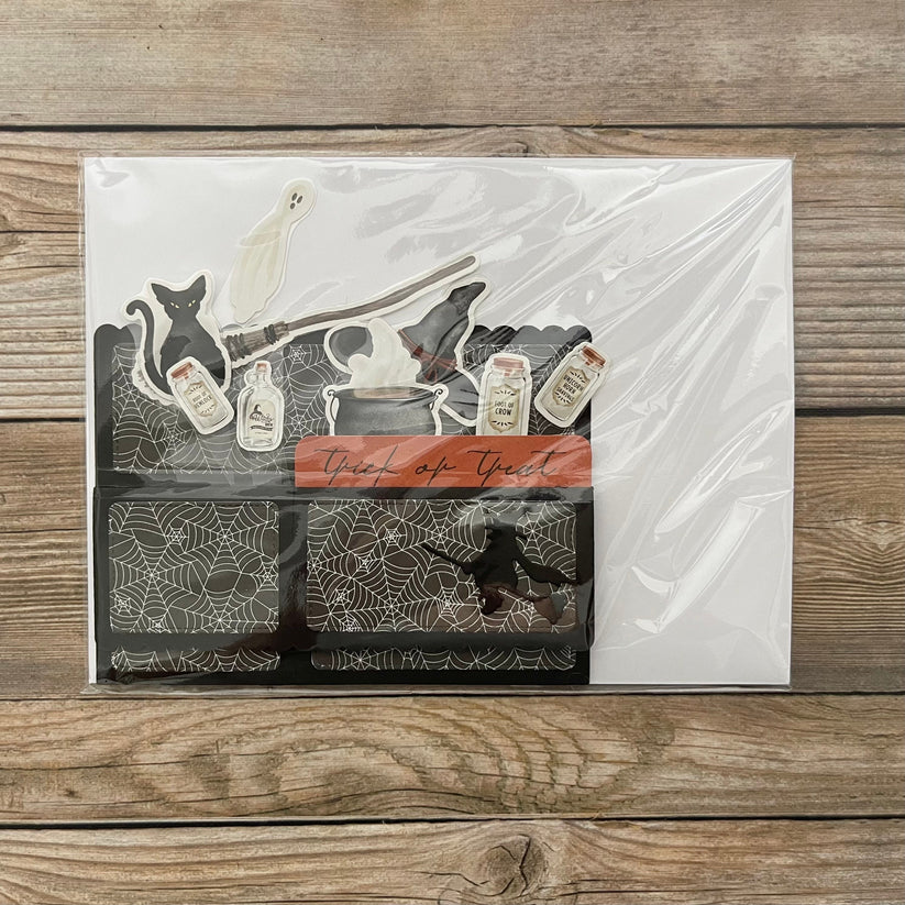 Halloween pop-up card in clear packaging on a wooden surface