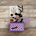 Halloween-themed pop-up card with witch, pumpkins, and cats on a wooden surface