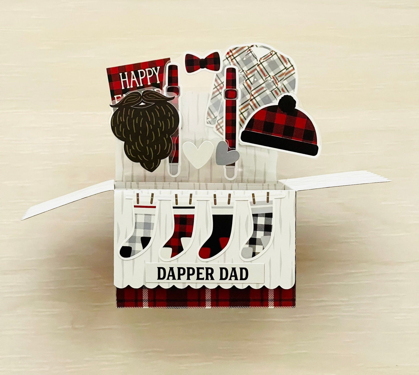 3D pop-up Card with plaid accessories and 'Dapper Dad' text on a beige background