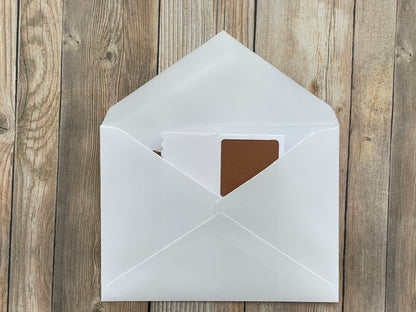 White envelope with a brown interior on a wooden surface