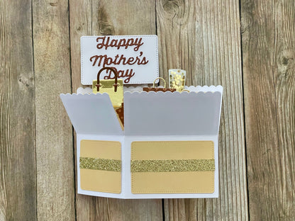 Open card with 'Happy Mother's Day' on a wooden background