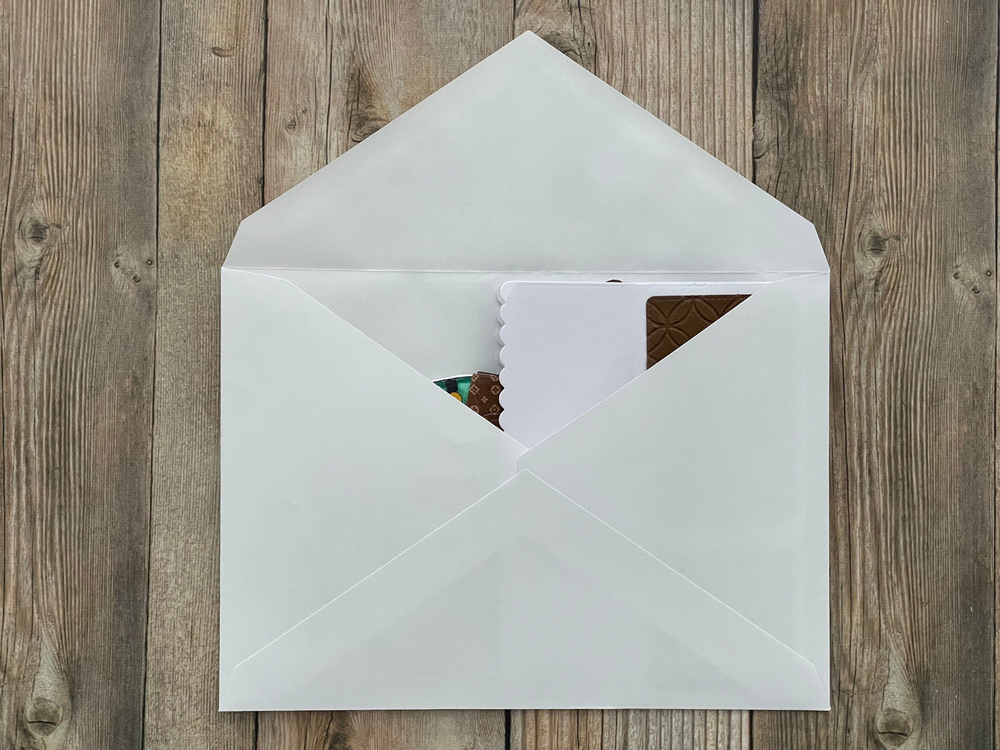 White envelope with a card on a wooden surface