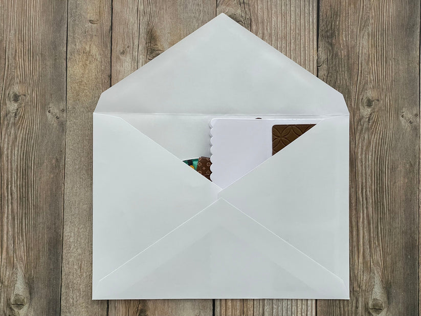 White envelope with a card on a wooden surface