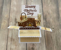 Pop-up card with 'Happy Mother's Day' on a wooden surface