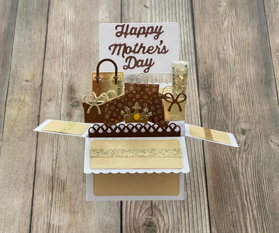 Pop-up card with 'Happy Mother's Day' on a wooden surface