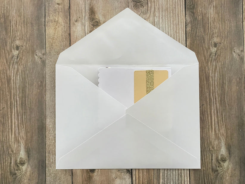 White envelope with a card inside on a wooden surface