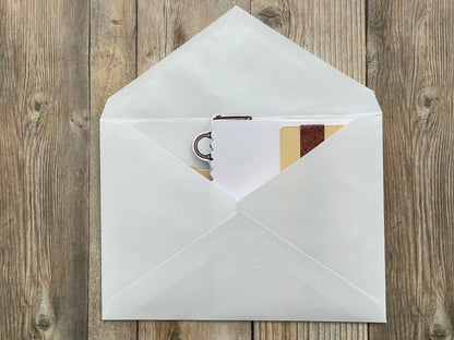 White envelope with a card inside on a wooden surface