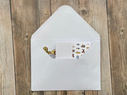 White envelope with stickers on a wooden surface