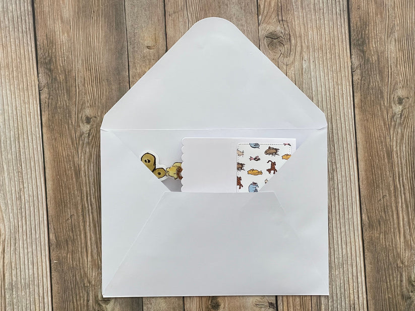 White envelope with stickers on a wooden surface