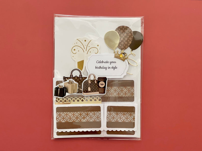 Decorative birthday card with shopping bag, cake, and balloon designs on a red background