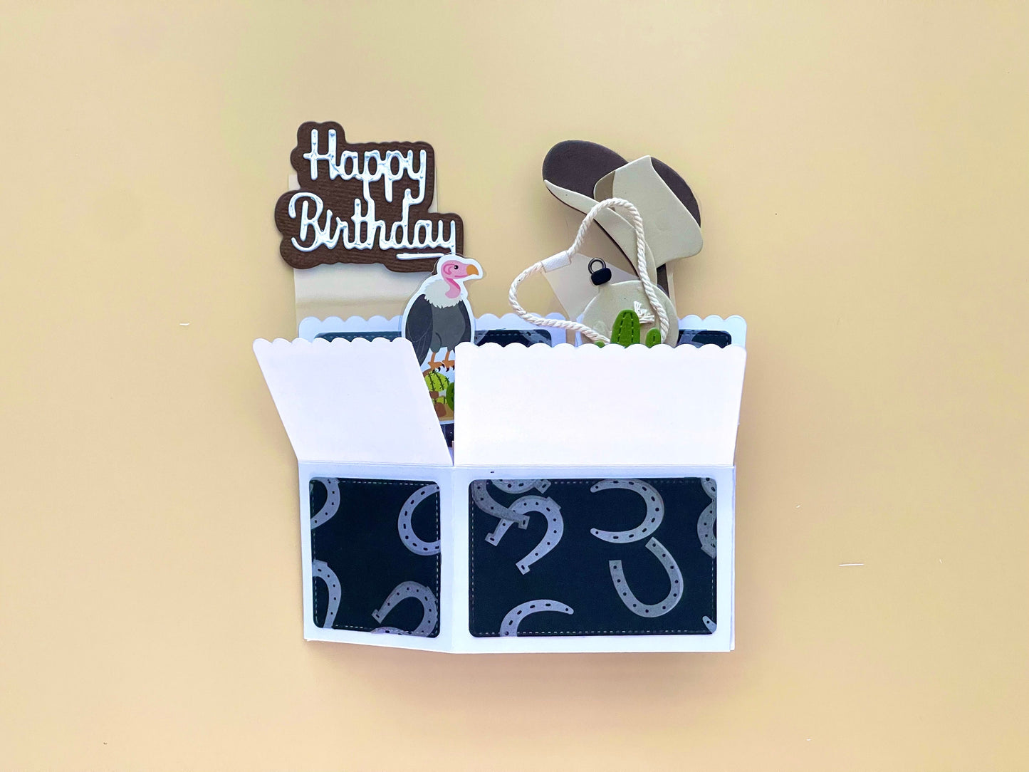 Open birthday card with horse design and 'Happy Birthday' text on a beige background