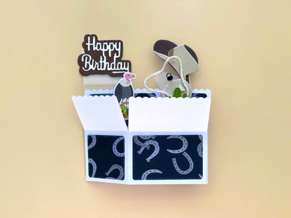 Open birthday card with horse design and 'Happy Birthday' text on a beige background