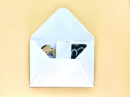 Open white envelope with a yellowish background