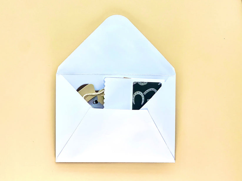 Open white envelope with a yellowish background
