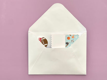 White envelope with colorful stationery items on a pink background