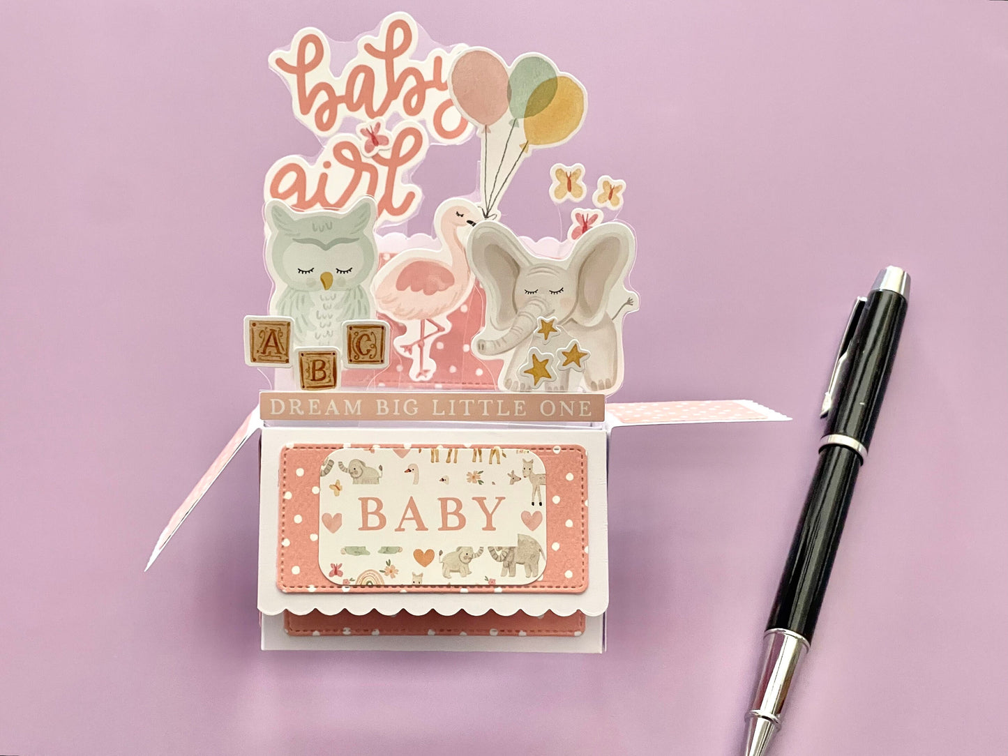 3D box pop-up card for baby girl with pink and white polka dots.  Shows an elephant, owl, flamingo and butterflies.