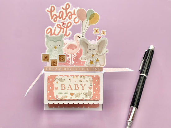 3D box pop-up card for baby girl with pink and white polka dots.  Shows an elephant, owl, flamingo and butterflies.