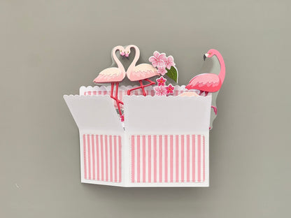 Folded flat pop up card with flamingo design on a gray background