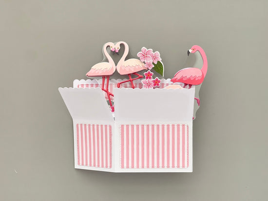 Folded flat pop up card with flamingo design on a gray background