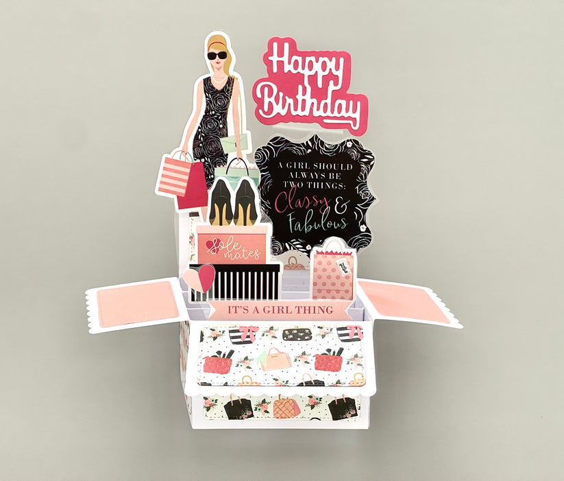 Decorative birthday card with shopping theme and 'Happy Birthday' text.