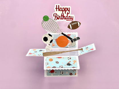Pop-up birthday card with sports-themed elements on a pink background