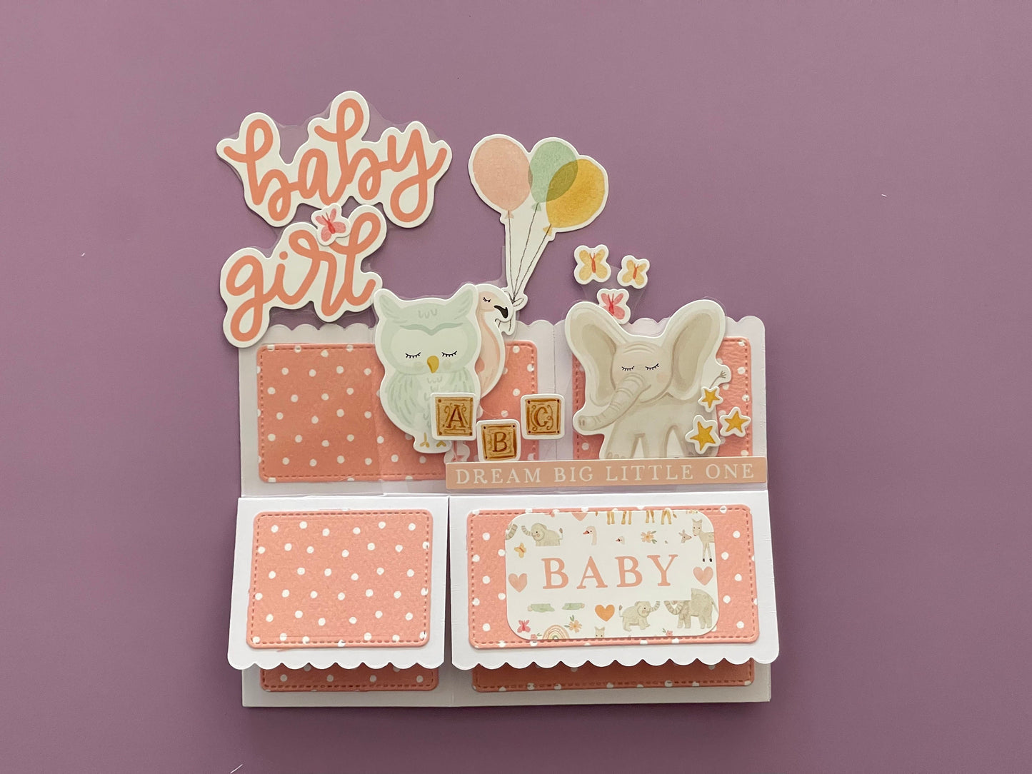 Decorative baby card with elephants and text on a purple background