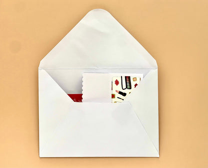 White envelope with a card inside on a beige background