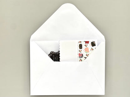 White envelope with a small card inside on a beige background