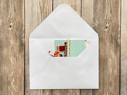 Envelope with a card inside on a wooden surface