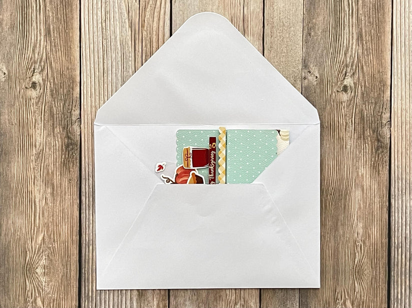 Envelope with a card inside on a wooden surface