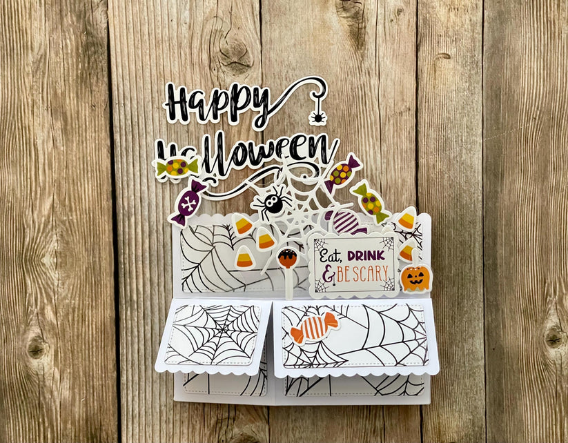 Halloween-themed pop-up card on a wooden background