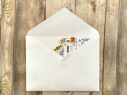 Decorative Halloween envelope with a sticker on a wooden surface