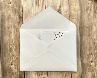White envelope with a card inside on a wooden surface