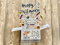Halloween-themed pop-up card with candy-themed elements on a wooden surface